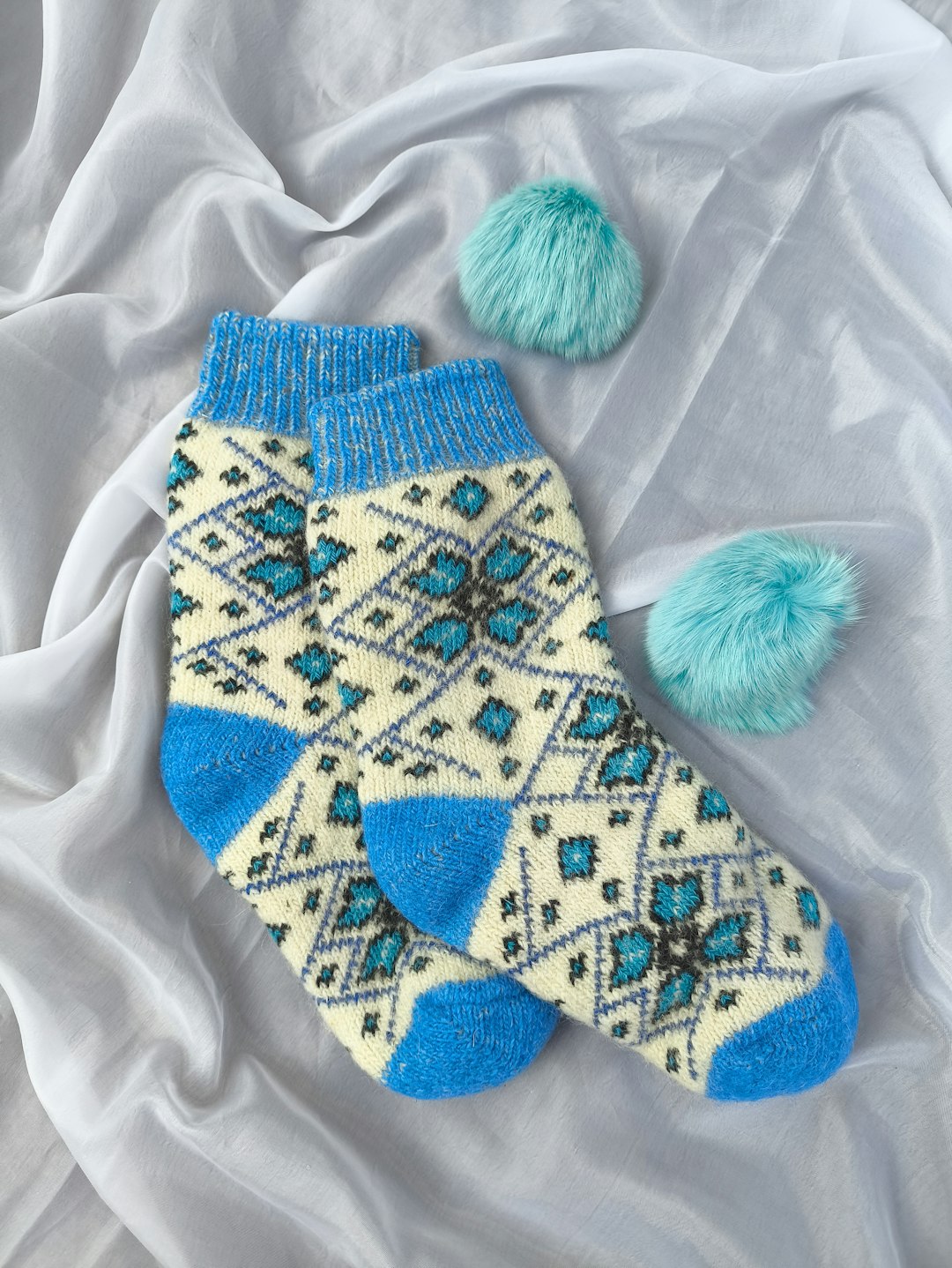 a-pair-of-blue-and-white-socks-with-pom-poms-pfuiyhgfmna