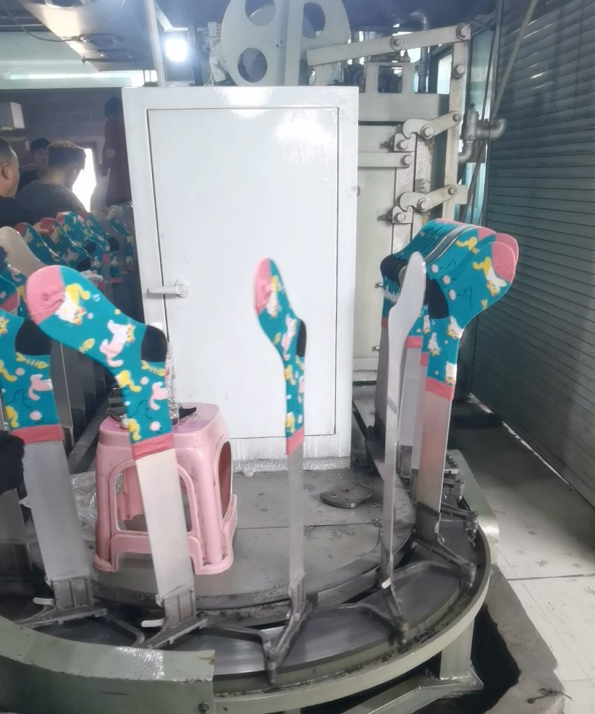 Custom socks on shaping machine at Winjet Socks factory in Zhuji, China